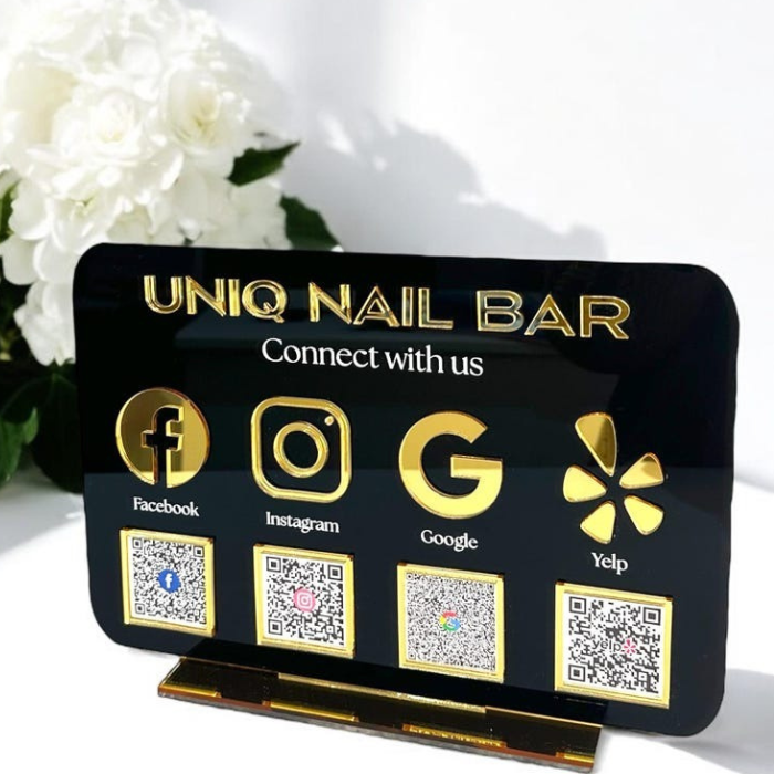 Black acrylic social media QR code sign with gold icons for Facebook, Instagram, Google, and Yelp, designed for business marketing and customer engagement.