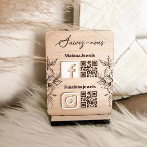 Custom wooden social media sign with QR codes for Facebook and Instagram, embossed logos, and the handle, designed for branding and customer engagement.