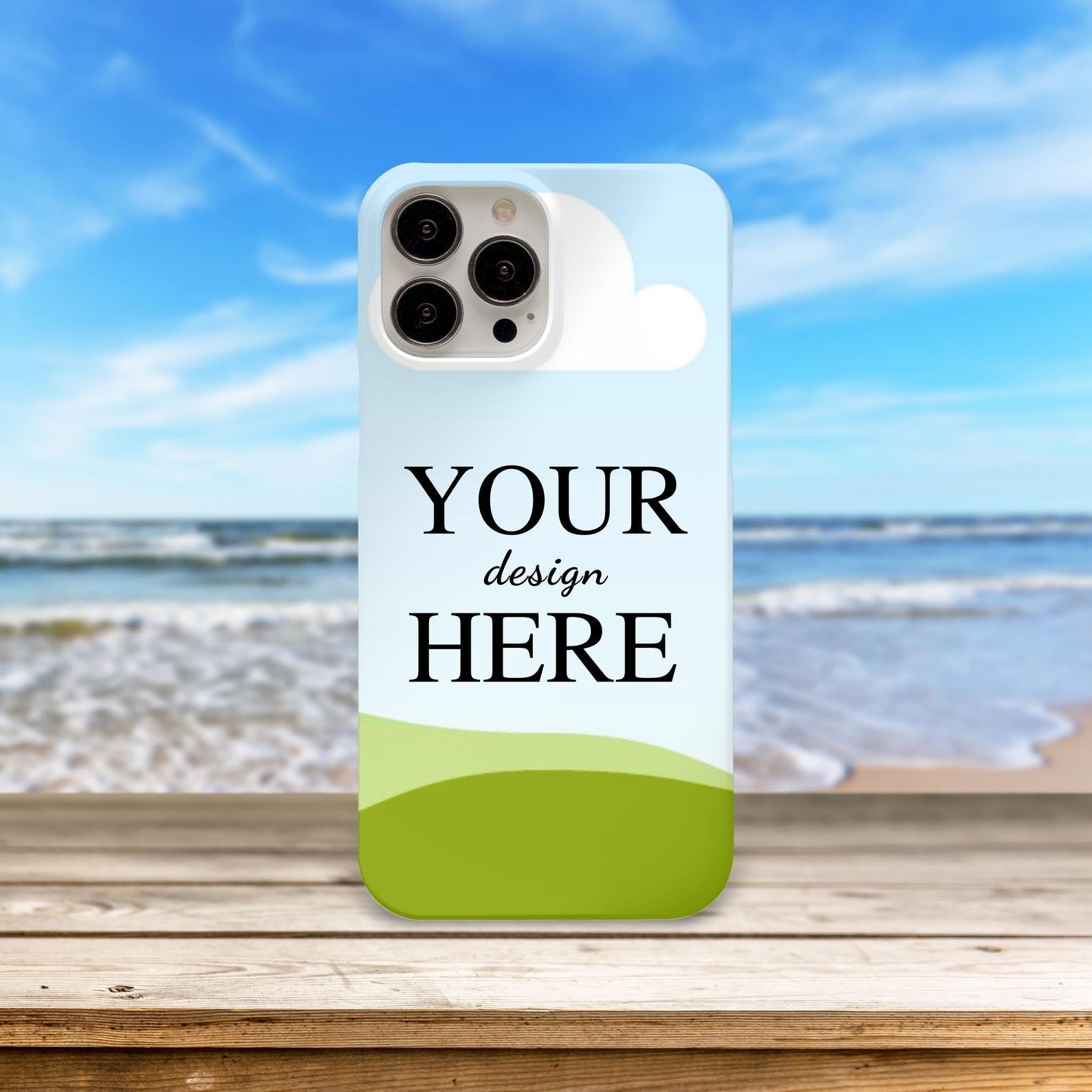 Customized mobile phone case with 'Your Design Here' displayed against a beach and ocean backdrop.