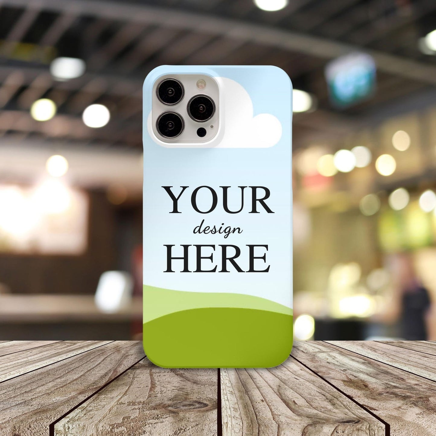 Personalized phone case featuring 'Your Design Here,' styled in an indoor setting with bokeh lighting effects