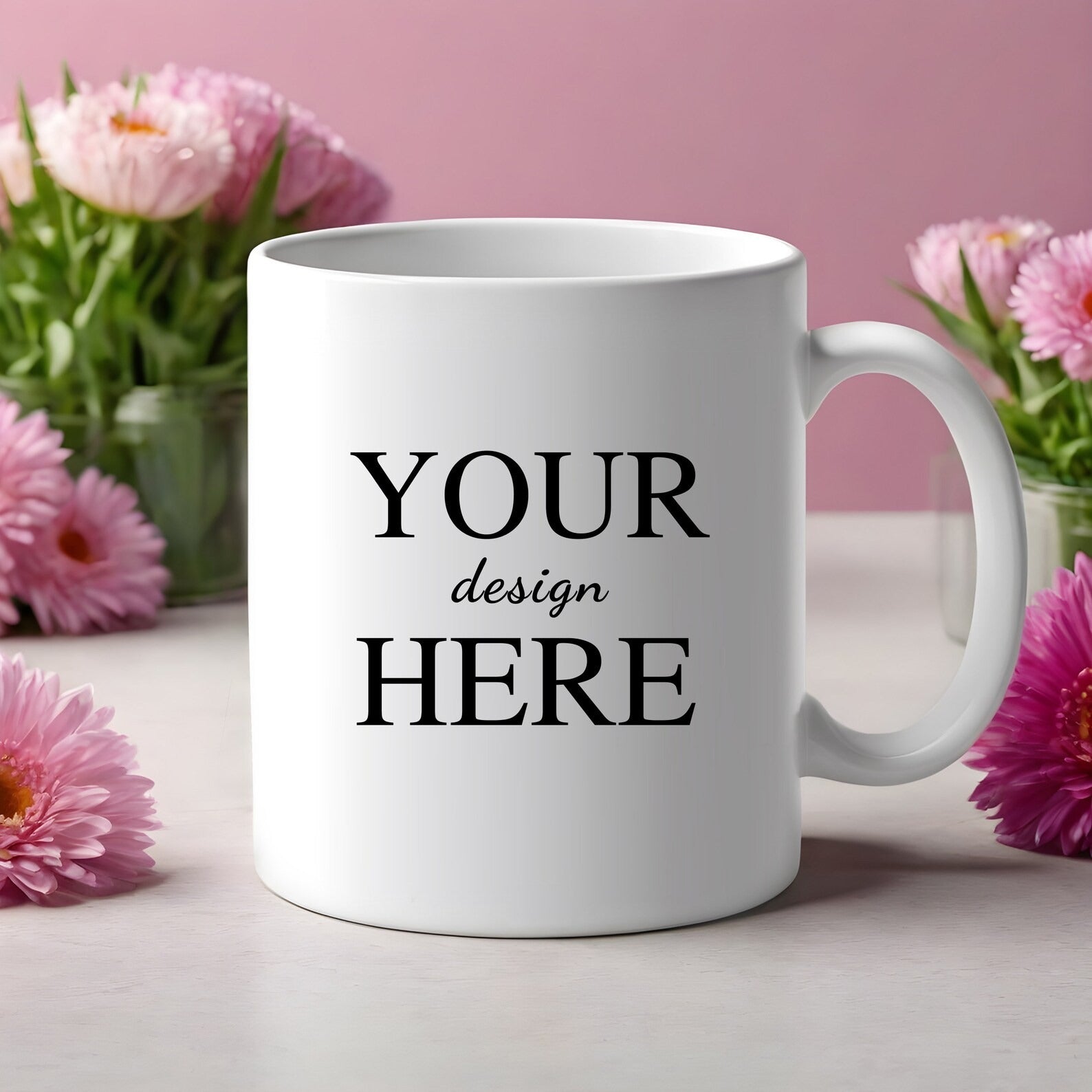 White ceramic customized mug with 'Your Design Here' text placed against a pink floral background, ideal for gifting purposes