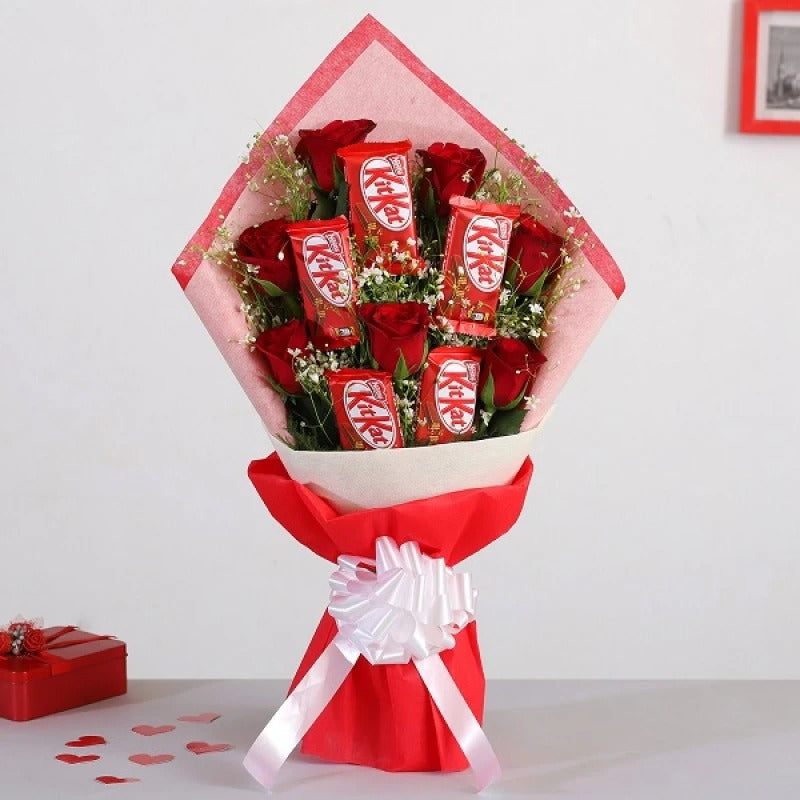 KitKat Chocolate and Red Roses Bouquet wrapped in red butter paper with white ribbon, ideal for gifting.