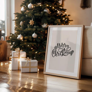 Elegant 'Merry Christmas' framed wall art displayed near a Christmas tree with festive lights and gifts