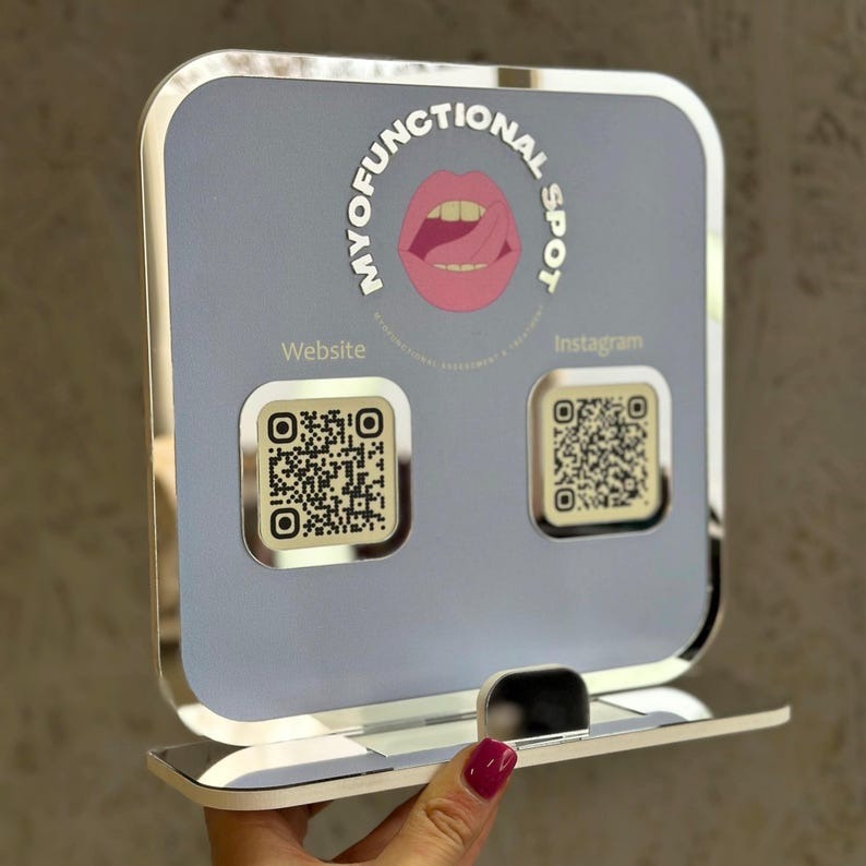 Light blue QR code sign for Myofunctional Spot, displaying website and Instagram links for easy access.