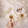 “Nikkah pen featuring elegant white feather design with personalized bride and groom names, luxury Islamic wedding signing pen with gold accents.