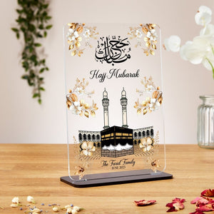 A premium Hajj Mubarak acrylic plaque with a Kaaba design, floral accents, and Arabic calligraphy, personalized with names and dates. Ideal for Hajj, Umrah, Eid, Nikkah, and Ramadan gifts.