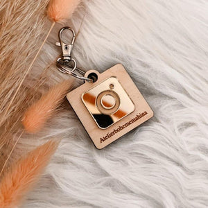  Personalized NFC Instagram keychain with golden emblem and wooden backing, engraved with Instagram handle.