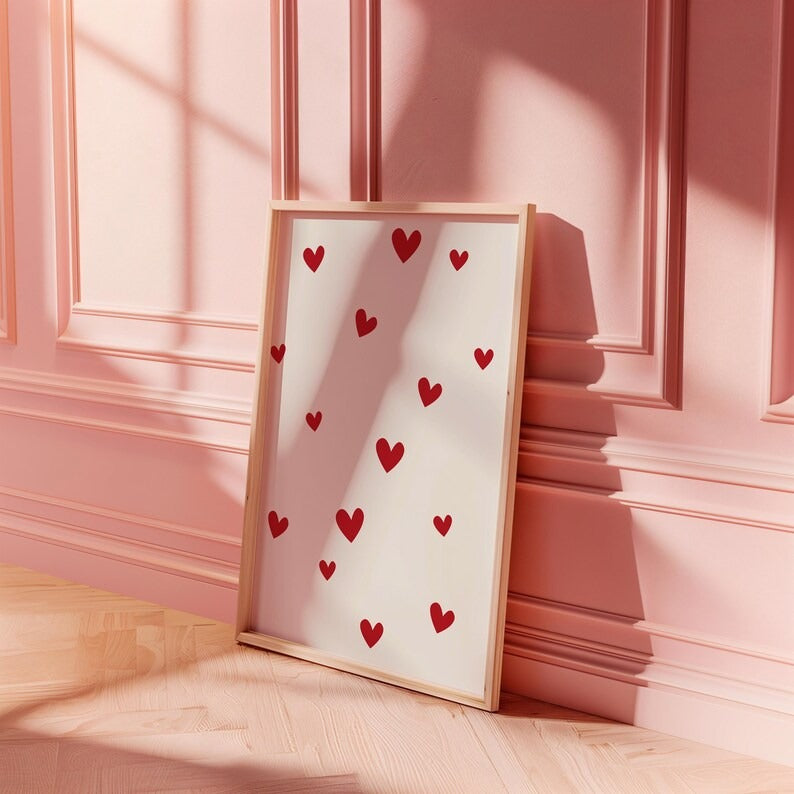 Minimalist heart-themed framed wall art with scattered red hearts, styled against a soft pink background for a romantic aesthetic.

