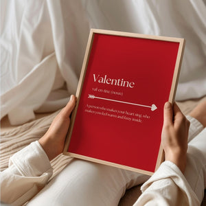 Framed Valentine’s Day love quote print held in hands, featuring a romantic definition and minimalist typography design.